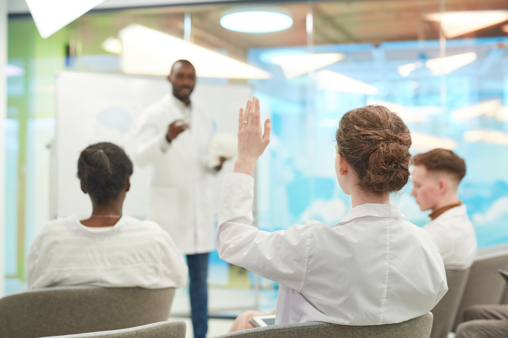 Medical conference People Raising Hands While Listening