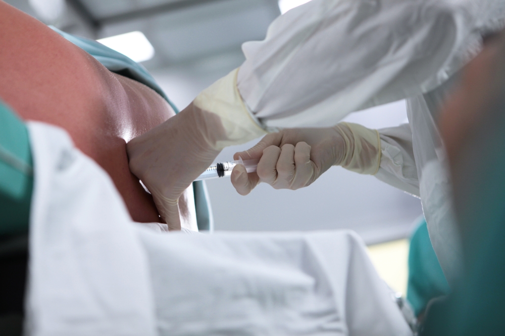 An Anesthesiologist Performs An Epidural Anesthesia On The Patient's Back
